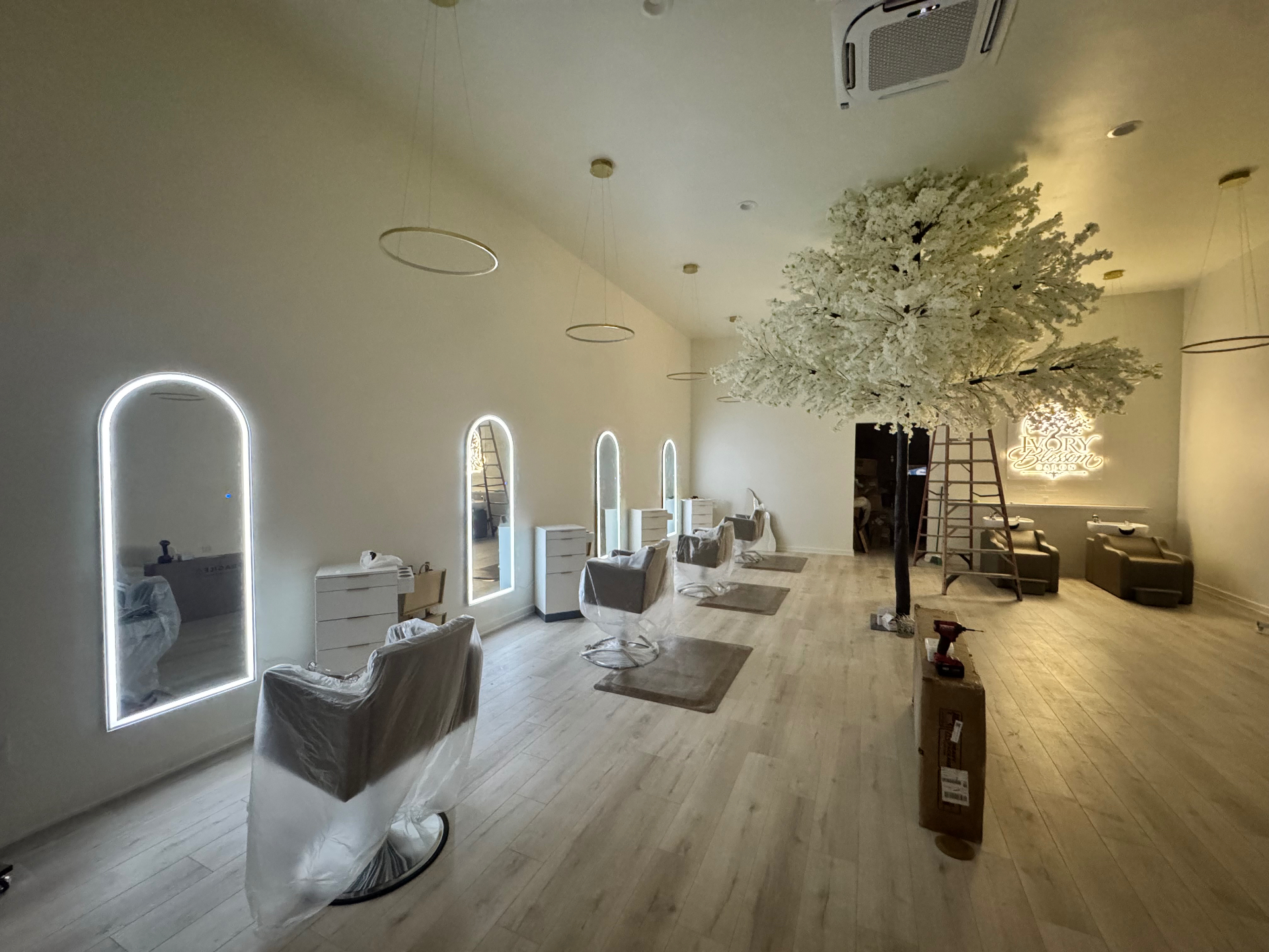 Finished Ivory Blossom Salon styling floor with illuminated mirrors, blossom tree and shampoo area