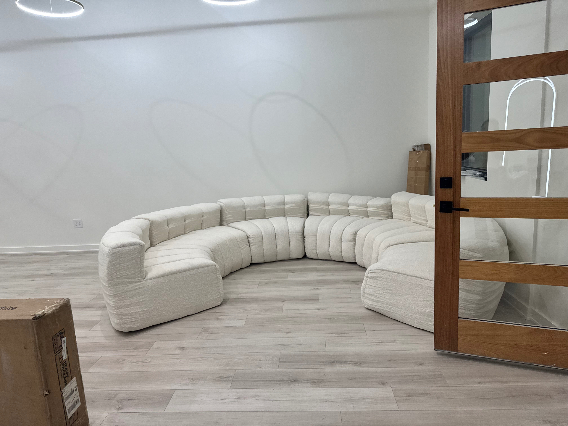 Curved ivory sectional in the finished waiting area at Ivory Blossom Salon in Broken Arrow